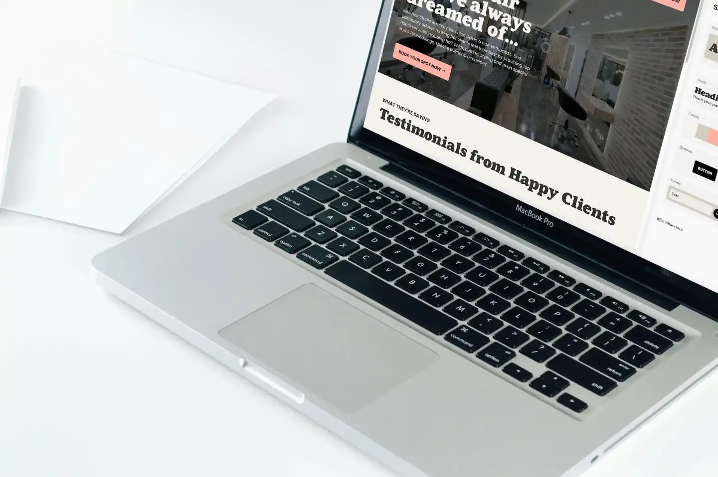 An open laptop showing a Lizzy Lane Designs website template for Squarespace.